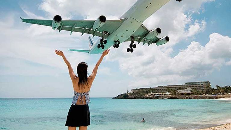 Planes frequently fly low over the beach in Maho Bay, the top resort destination in St. Maarten.  // © 2013 Mark Edward Harris