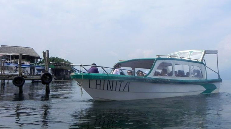 A boat in Lake Atitlan, Guatemala, brings visitors to various Maya villages nestled within three volcanoes. // (c) 2013 ASTA YPS
