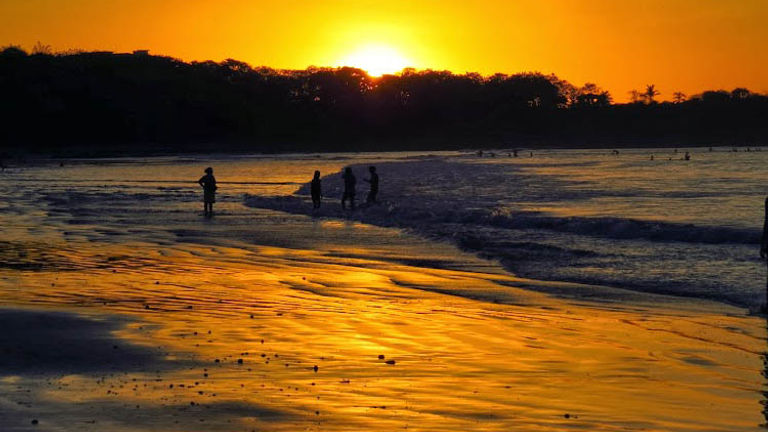 Sunset casts an orange glow on Tamarindo. // © 2014 Nikki Gloudeman