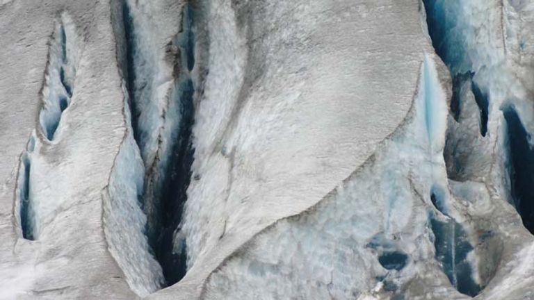 Ice in the glacier is likely hundreds of years old, and the blue color means that most of the air has been squeezed out by the weight of subsequent snowfalls.  // © 2014 Dennis Sides
