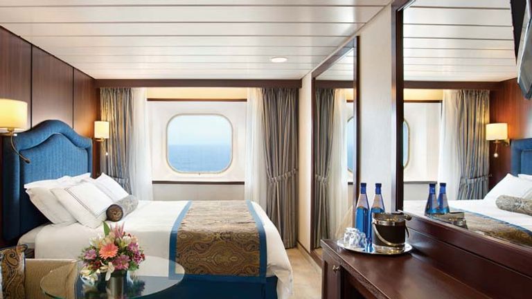 After: To create a brighter atmosphere, heavy drapery on picture windows were removed and new floor coverings added, making Regatta’s accommodations look more like those on the brand’s newer ships. // © 2014 Oceania Cruises