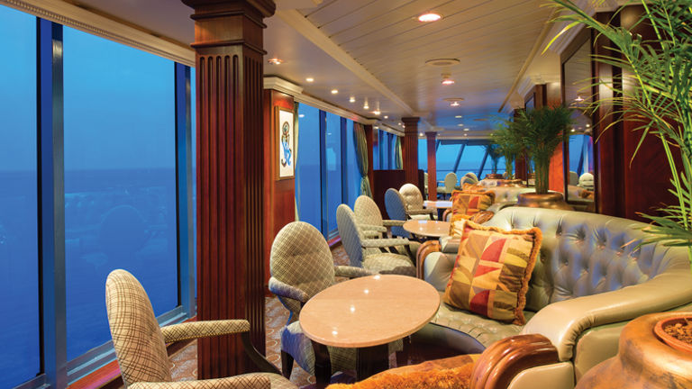 After: A great place for taking in sea views, the Horizons observation lounge now has updated and lighter-colored furnishings. // © 2014 Oceania Cruises