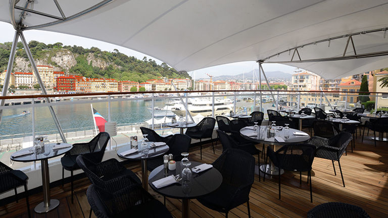 Lunch venue Veranda offers expanded outdoor seating, along with a courtyard and garden wall. At night, it transforms into dinner spot Candles. // © 2016 Windstar Cruises