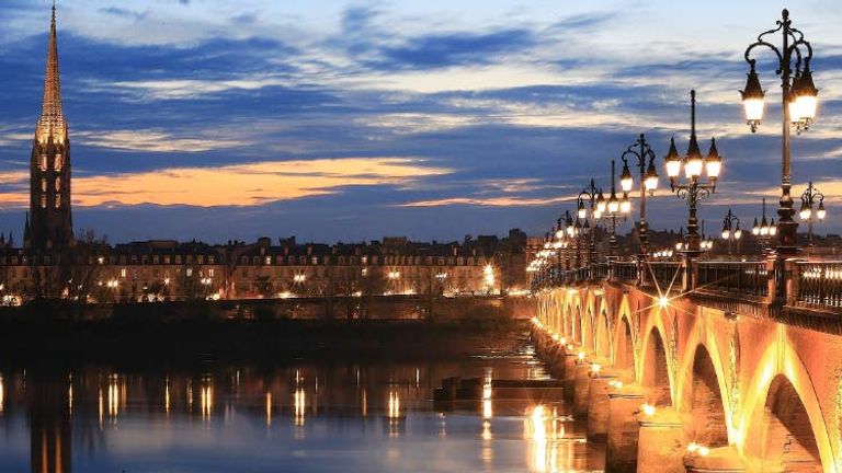 Take a romantic walk over an illuminated bridge in Bordeaux. // © 2015 iStock