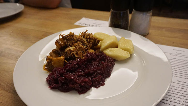 Order slow-roasted pork belly, accompanied with potato dumplings and red cabbage, to soak up the rounds of beer. // © 2016 Valerie Chen