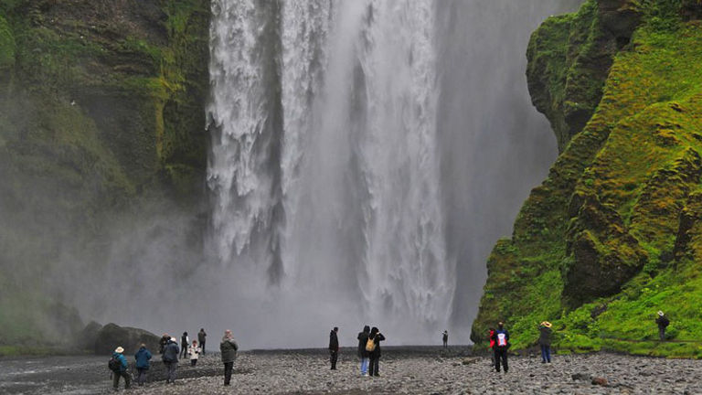 Skogafoss is one of the three waterfalls that guests can see on Discover Iceland’s Discover the South Coast & Eyjafjallajokull Volcano tour. // © 2014 Discover Iceland