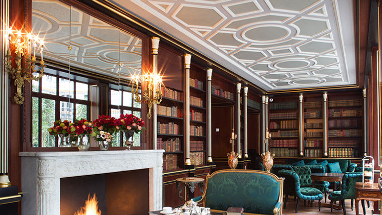 An on-site library stocked with antique books // © 2015 La Reserve Paris Hotel and Spa