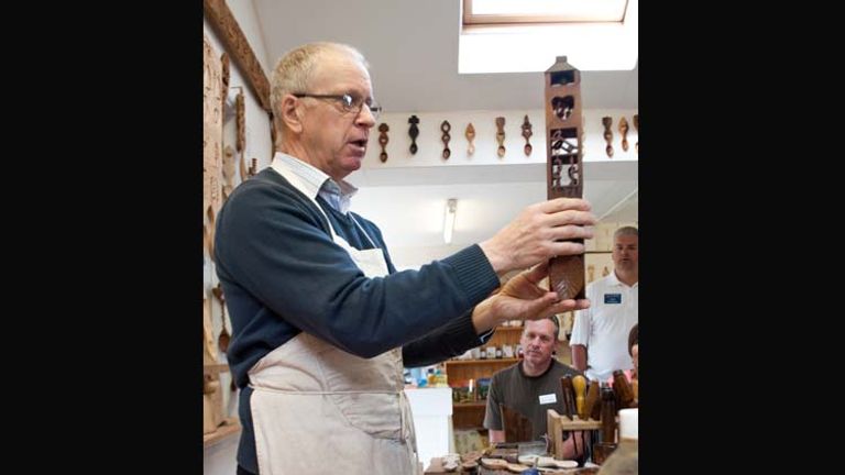 Kerry Thomas, also known as Thomas the Woodcarver, explains the art form to groups who visit his Lovespoon Workshop. // © 2014 Mindy Poder