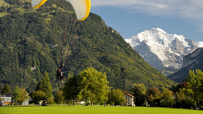 Paragliders will land safely in a park after their sky-high excursion. // © 2016 Interlaken Tourism