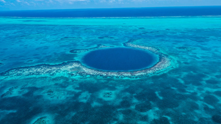 The Great Blue Hole in Belize features submerged stalagmites and stalactites. // © 2016 Belize Tourism Board