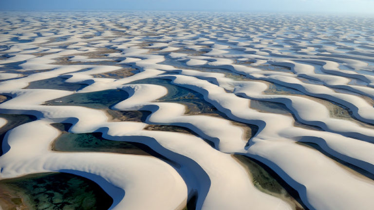 Brazil's Lencois Maranhenses National Park features thousands of aqua-colored lagoons tucked into dunes. // © 2016 iStock