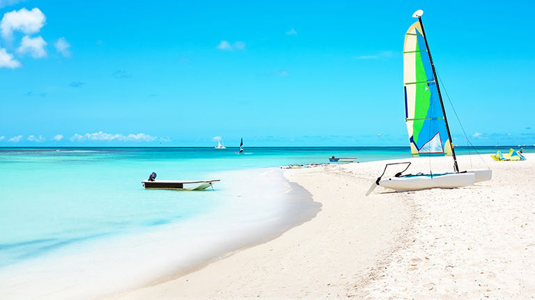 Naturists and clothing-optional travelers can get onboard Bare Necessities’ “Big Nude Boat” cruise, which has a stop in Aruba. // © 2017 iStock