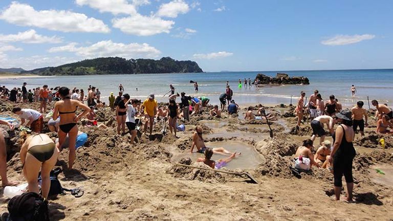 Make sure to pack a shovel to make your own hot spring before heading out to New Zealand's Hot Water Beach. // © 2017 Wikimedia Commons