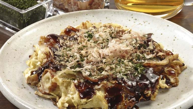 Often diners choose their own mix ins when ordering this Japanese savory pancake; it’s name derives from the term “okonomi,” which means “what you like.” // © 2014 Thinkstock
