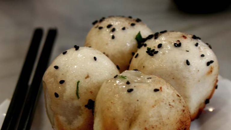 Easily found on the streets of Shanghai, shen jian bao are stuffed with pork and fried until the bottoms are brown and crispy. // © 2014 Richard Lowe