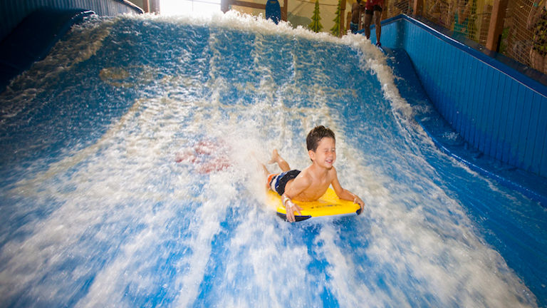 Try your hand at boogie boarding on simulator Wolf Rider Wipeout. // © 2016 Great Wolf Lodge