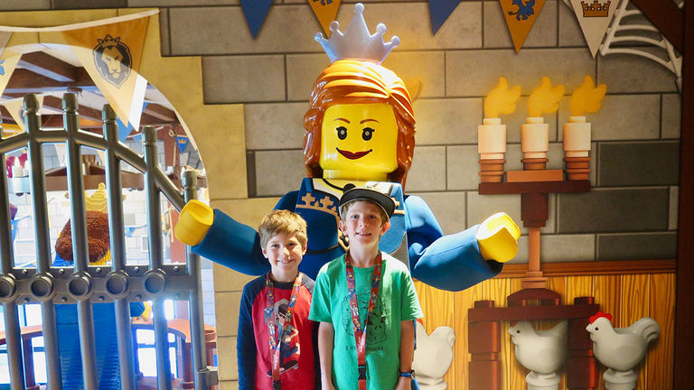 Asher and Elijah Smith pose with a Lego statue of Princess Brickney.
