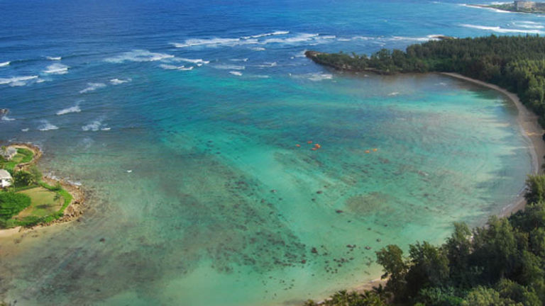 Kawela Bay is a great destination for families, as it offers calm waters for beginning kayakers and paddleboarders. // © 2014 Shaka Kayaks