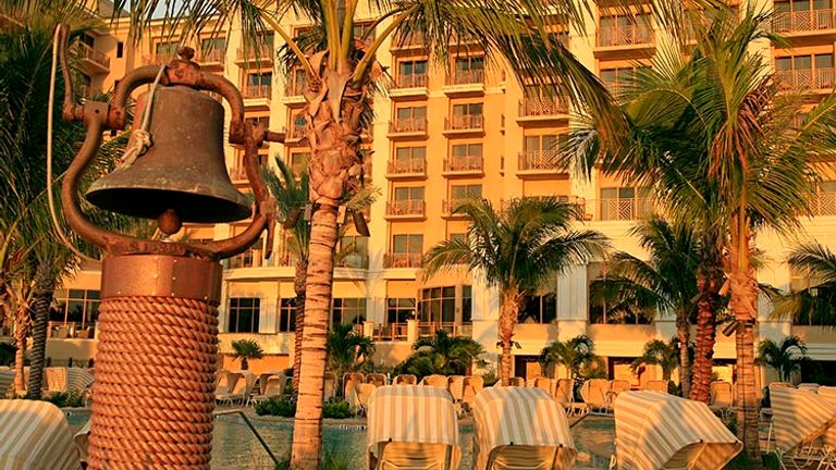 A young guest rings the historic dinner bell each evening at meal time. // © 2016 Sandpearl Resort Clearwater Beach