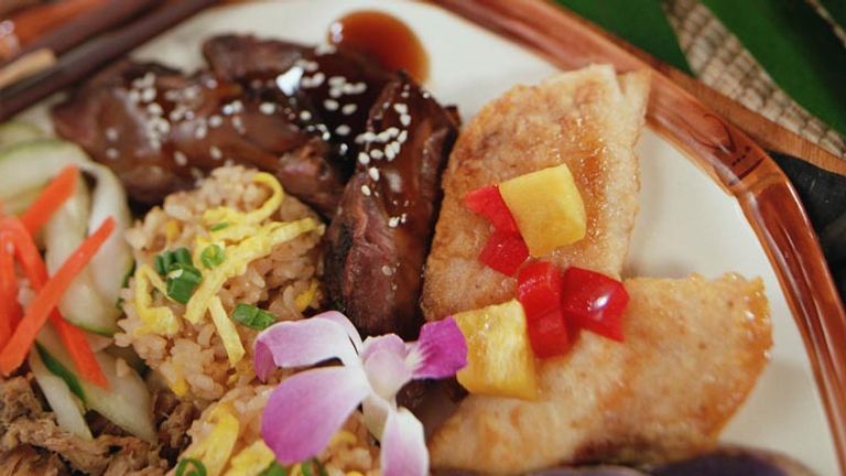 Island-style food, drinks and aloha spirit satisfy guests at Smith Family Garden Luau on Kauai. // © 2013 Smith's Tropical Paradise