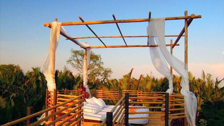Only bamboo railing and lightweight drapes separate guests from nature at Bangkok Tree House in Thailand. // © 2015 Bangkok Tree House
