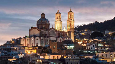 Evening over the famous Baroque church of Santa Prisca in Taxco, Mexico. The colonial town of Taxco is a UNESCO World Heritage Site. // © 2013 istock: stockcam