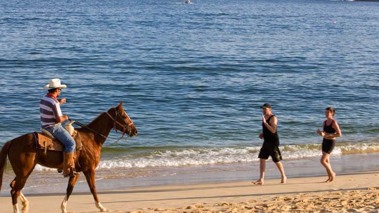 At Lover's Beach in Los Cabos, clients can play in the waves against the backdrop of Cabo’s iconic El Arco rock arch. (c) 2013 Los Cabos Convention & Visitors Bureau