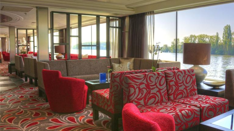 The Main Lounge features a deep red decor. // (c) 2013 Avalon Waterways