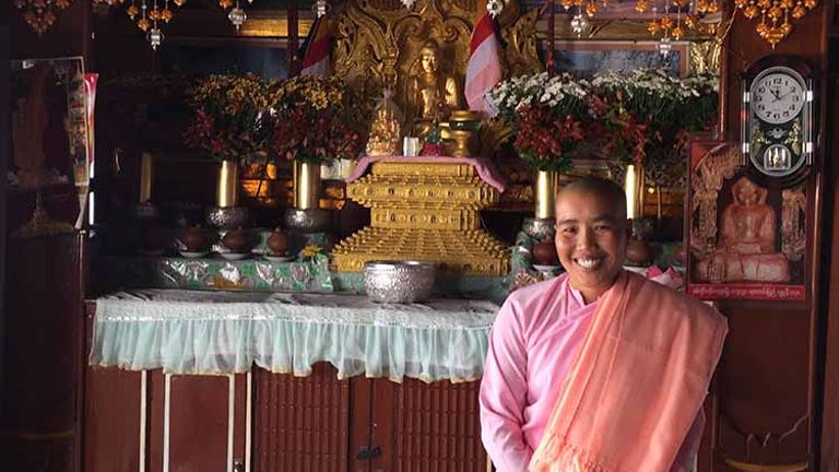 A Buddhist nun shows visitors her shrine. // © 2016 Kenneth Shapiro