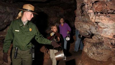 At Wind Cave National Park, visitors are guided by candlelight in a handheld bucket. // © 2014 Wind Cave National Park
