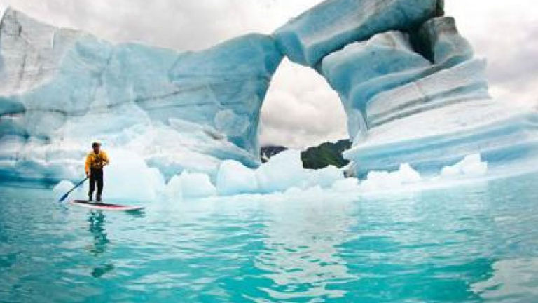 Visitors can try paddleboarding next to icebergs and glaciers. // © 2014 Kenai Fjords National Park