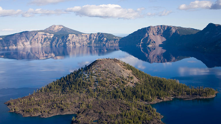 Visitors can catch a boat tour or shuttle to Wizard Island, a volcanic cinder cone. // © 2016 iStock
