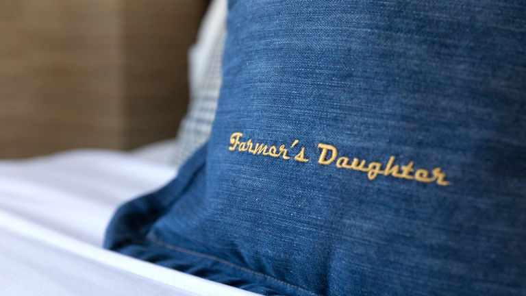 Guestrooms showcase branded denim pillows.