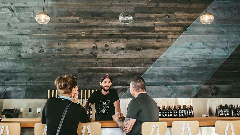 Able Seedhouse + Brewery’s design includes concrete furniture and Japanese burnt wood. // © 2016 Brandon Werth
