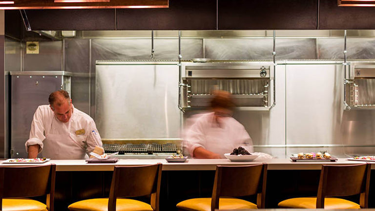 Diners near the open kitchen can watch as chefs masterfully whip up tasty dishes. // © 2017 Victor M. Samuel