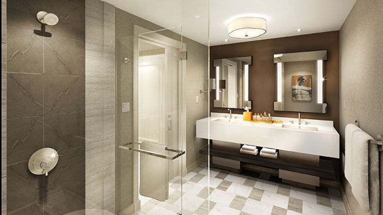 Redesigned bathrooms in the Julius Tower at Caesars Palace Las Vegas feature stone tile and modern artwork. // © 2016 Caesars Entertainment
