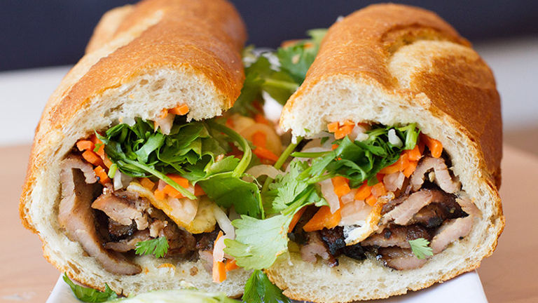 At Nong La, patrons chow down on vibrant Vietnamese food, including banh mi sandwiches, pho soup and more. // © 2016 Platful/Nong La