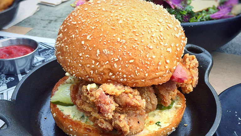 Plan Check Kitchen + Bar, a popular gastropub offering unique burgers and a Southern Fry (pictured) sandwich, is a must-stop. // © 2016 Creative Commons user T.Tseng