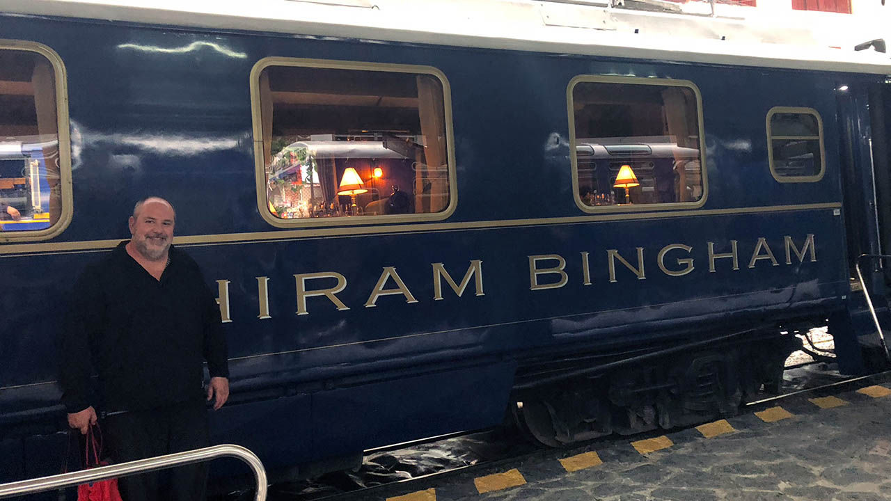 The writer standing next to the Belmond Hiram Bingham train