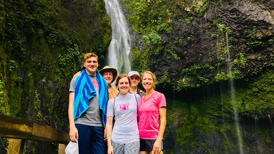 The writer (back right) and his family during a waterfall hike in Fiji