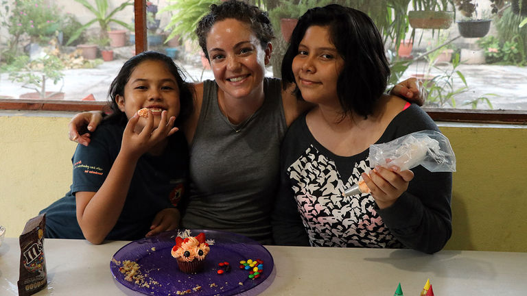 A Na’atik participant makes cakes with her homestay family.
