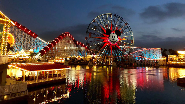 At night, Pixar Pier comes to life with colorful lights.