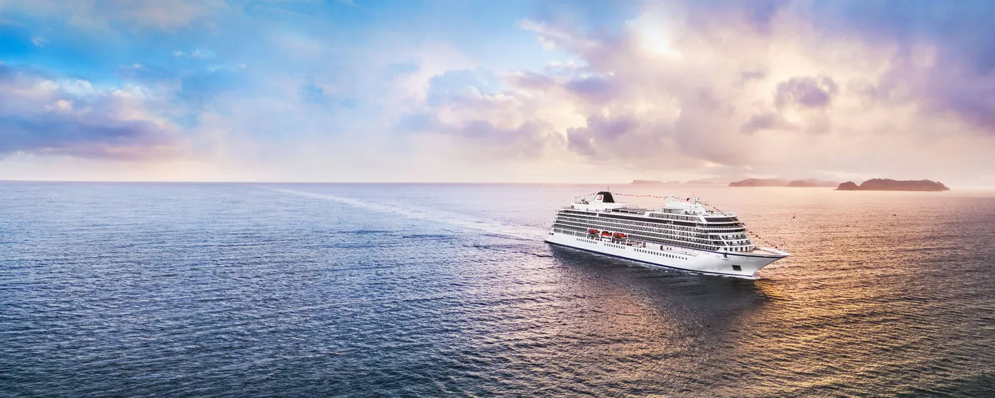 Luxury cruise ship on open ocean at sunrise