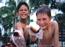Hawaiian kids showing off their spam musubi // © 2010 Oahu Visitors Bureau Hawaiian kids showing off their spam musubi // © 2010 Oahu Visitors Bureau