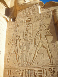 Clients can still see temple inscriptions on the facade of the structure. // (c) Shannon Hobbs