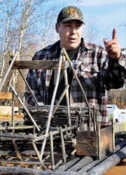 Tour guide and local resident Cliff Adams explains to visitors the way of life in Beaver, Alaska. // (C) 2010 Christopher Batin