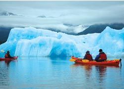 Kayakers pass icebergs in Heather Bay with Pangaea Adventures. // (C) 2010 Christopher Batin