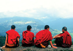 Young monks of Rumtek Monastery in the Himalayas enjoy awesome valley views. // (c) Graham Simmons