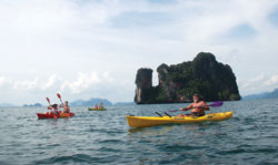 John Gray (right) helms a sea-fari out on the open sea amidst the limestone islands at Phang Nga Bay. // (c) Ed Rampell