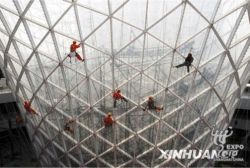 Chinese workers work on the horn-shaped 'Sunny Valley' building which lines Expo Boulevard at the World Expo site in Shanghai // (c) 2009